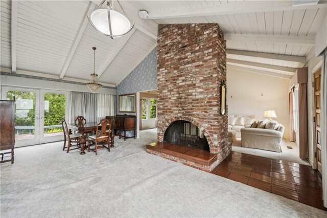 24940 Outlook Dr, Carmel, CA 93923 - living area with french doors, a fireplace, carpet, a chandelier, and beamed ceiling