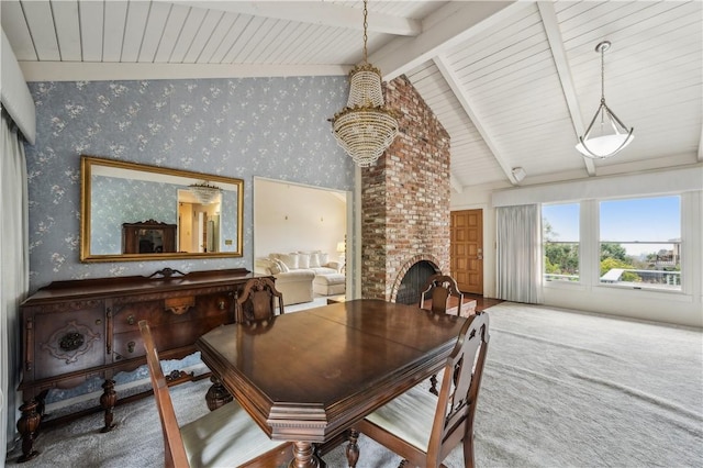 carpeted dining space featuring wooden ceiling, vaulted ceiling with beams, a fireplace, and wallpapered walls