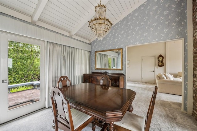 carpeted dining area with an inviting chandelier, lofted ceiling with beams, and wallpapered walls