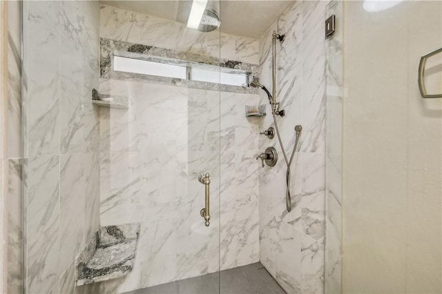 full bath featuring a marble finish shower