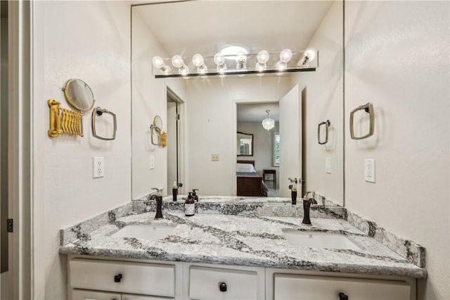 ensuite bathroom with double vanity, a sink, and ensuite bathroom