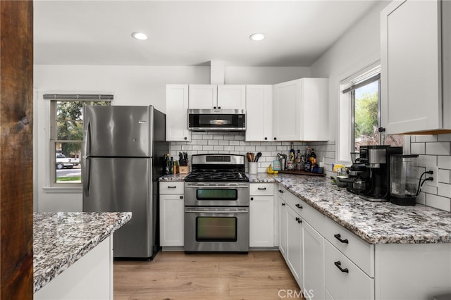 1326 Clock Ave, Redlands, CA 92374 - kitchen featuring appliances with stainless steel finishes, a wealth of natural light, and light stone countertops