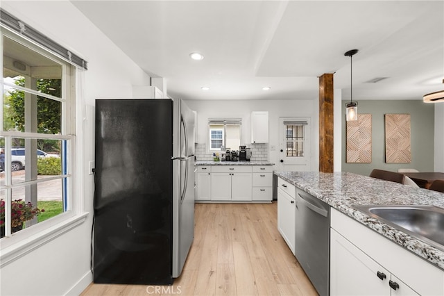 1326 Clock Ave, Redlands, CA 92374 - kitchen featuring white cabinets, appliances with stainless steel finishes, light wood-style flooring, recessed lighting, and decorative light fixtures