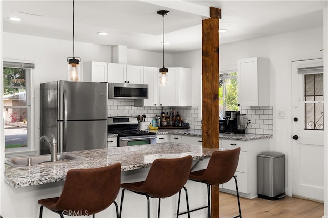 1326 Clock Ave, Redlands, CA 92374 - kitchen featuring backsplash, stainless steel appliances, a breakfast bar, and a sink