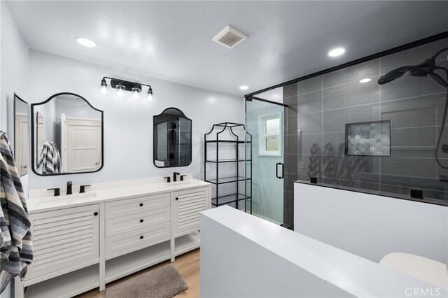 1326 Clock Ave, Redlands, CA 92374 - full bathroom with double vanity, a shower stall, recessed lighting, and visible vents