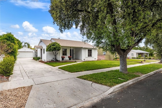 1326 Clock Ave, Redlands, CA 92374 - view of front of house featuring a detached garage, an outdoor structure, a front yard, and stucco siding