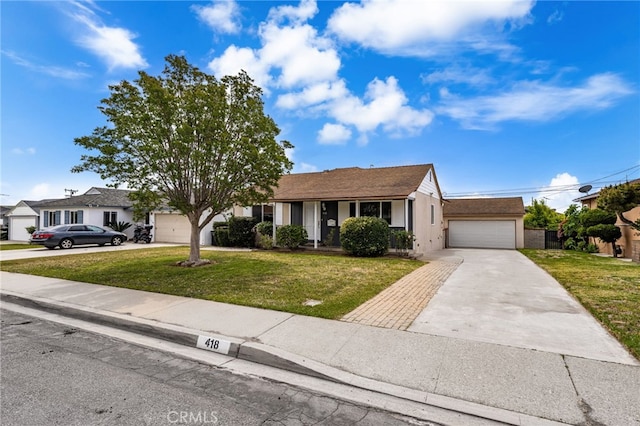 view of front facade with stucco siding, an attached garage, driveway, and a front yard