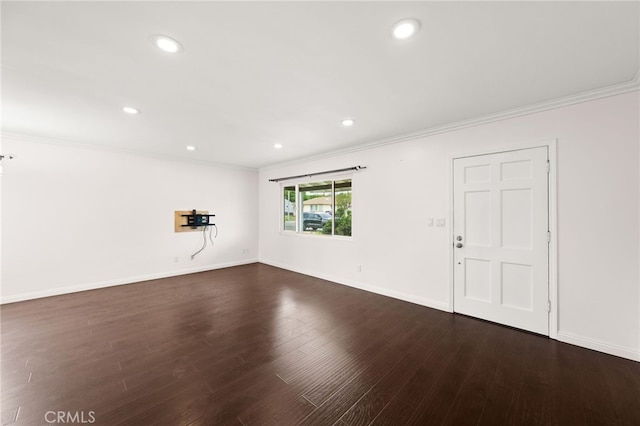unfurnished living room with crown molding, recessed lighting, dark wood finished floors, and baseboards