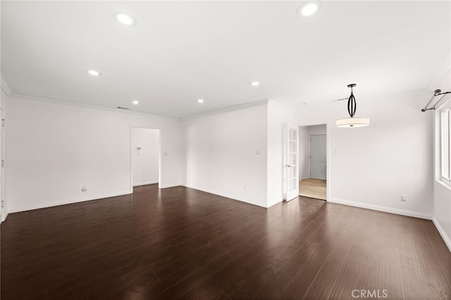 empty room with crown molding, recessed lighting, baseboards, and wood finished floors