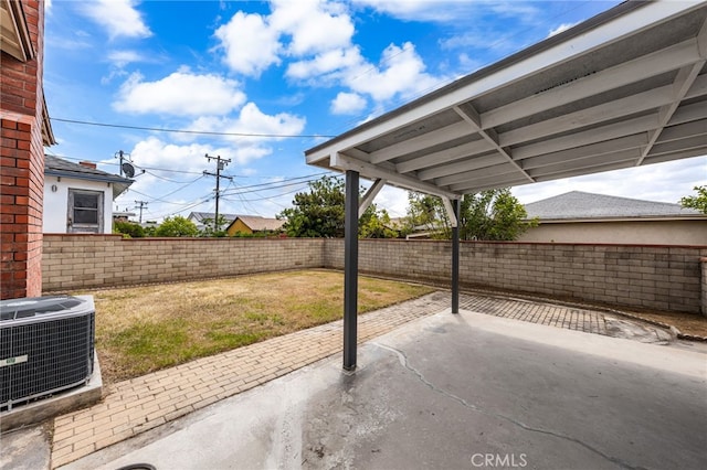 view of patio / terrace with central air condition unit and a fenced backyard