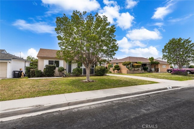 obstructed view of property featuring a front lawn