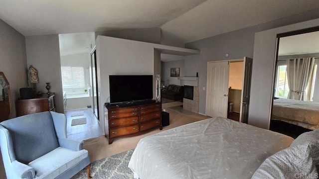 42154 Thoroughbred Ln, Murrieta, CA 92562 - bedroom with light carpet, lofted ceiling, and a tile fireplace