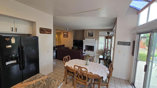 42154 Thoroughbred Ln, Murrieta, CA 92562 - dining area featuring light tile patterned flooring, visible vents, a wealth of natural light, and a fireplace