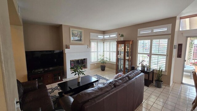 42154 Thoroughbred Ln, Murrieta, CA 92562 - living room featuring healthy amount of natural light, a glass covered fireplace, and light tile patterned floors