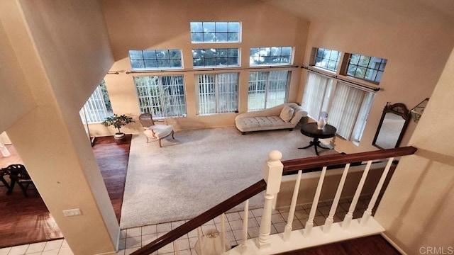 42154 Thoroughbred Ln, Murrieta, CA 92562 - staircase with a towering ceiling and wood finished floors