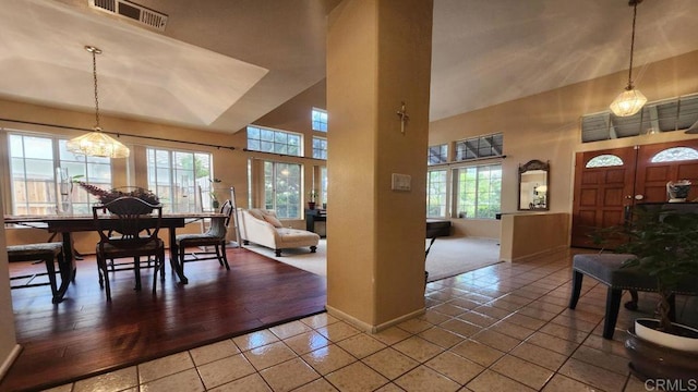 42154 Thoroughbred Ln, Murrieta, CA 92562 - dining room featuring tile patterned floors, plenty of natural light, a high ceiling, and a chandelier