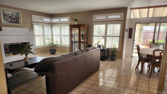 42154 Thoroughbred Ln, Murrieta, CA 92562 - living room with a glass covered fireplace and light tile patterned floors