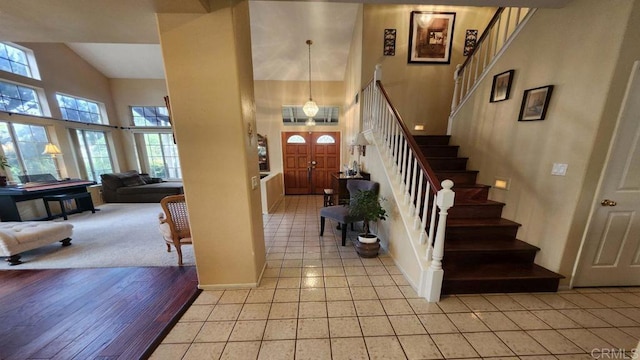 42154 Thoroughbred Ln, Murrieta, CA 92562 - foyer with high vaulted ceiling, stairs, plenty of natural light, and light tile patterned flooring