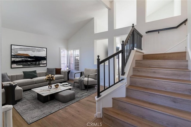 26928 Eagle Run St, Corona, CA 92883 - living room featuring wood finished floors, stairway, and high vaulted ceiling