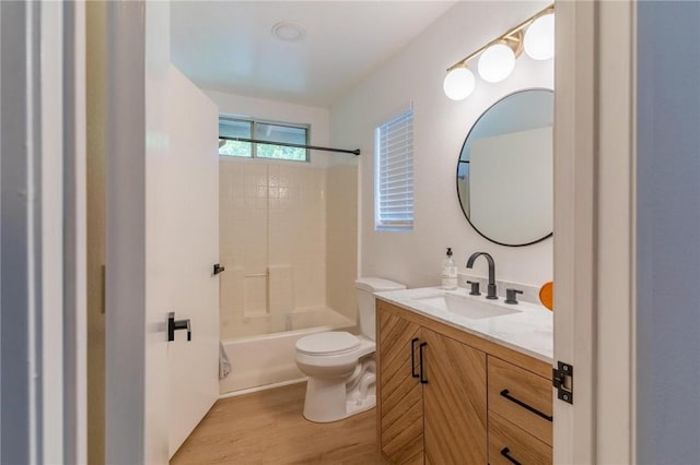 bathroom with vanity, bathtub / shower combination, toilet, and wood finished floors