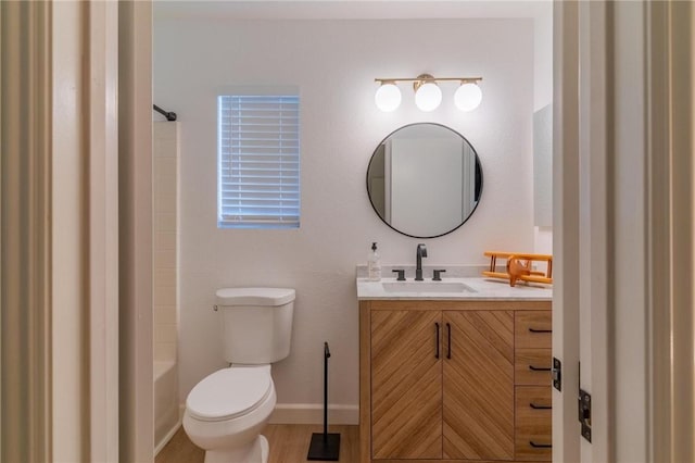 full bathroom with vanity, toilet, baseboards, wood finished floors, and shower / bathing tub combination