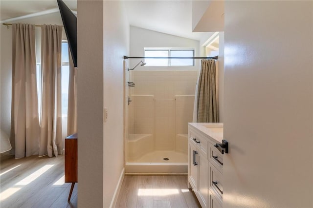 26928 Eagle Run St, Corona, CA 92883 - bathroom featuring wood finished floors, a stall shower, and vaulted ceiling