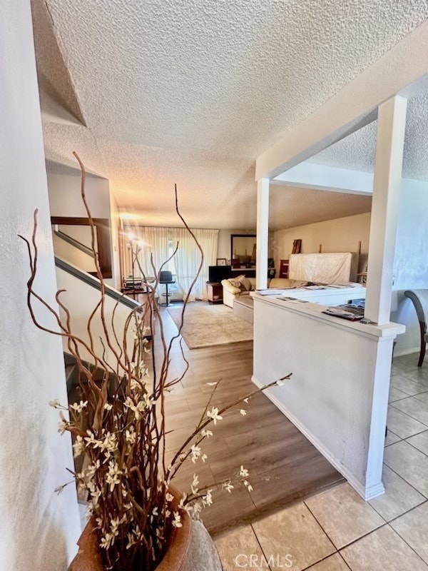 interior space featuring a textured ceiling and tile patterned flooring