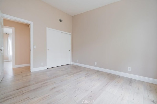 56 Egret Ln, Aliso Viejo, CA 92656 - unfurnished bedroom with light wood-style floors, a closet, and baseboards