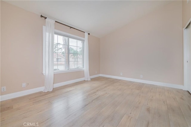 56 Egret Ln, Aliso Viejo, CA 92656 - unfurnished room featuring light wood-type flooring, baseboards, and vaulted ceiling