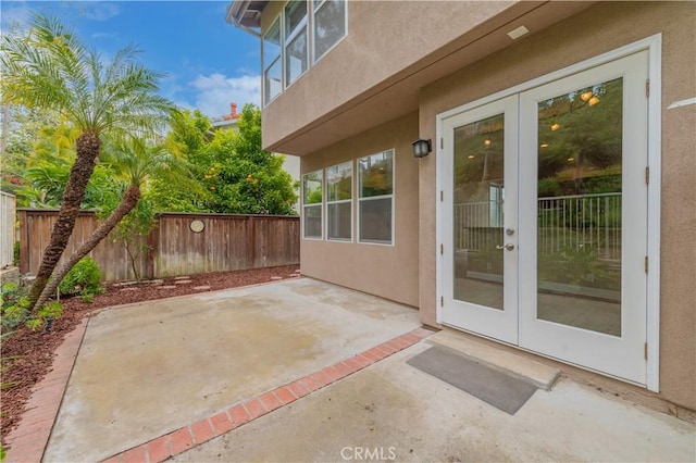 view of patio with french doors and a fenced backyard