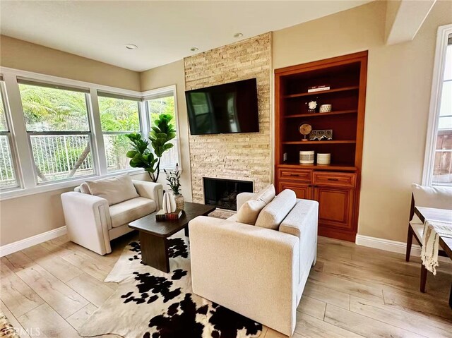 56 Egret Ln, Aliso Viejo, CA 92656 - living area featuring baseboards, a fireplace, and light wood-style flooring