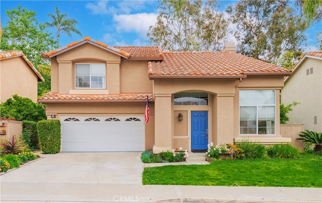 mediterranean / spanish-style home featuring stucco siding, a chimney, a tiled roof, an attached garage, and driveway