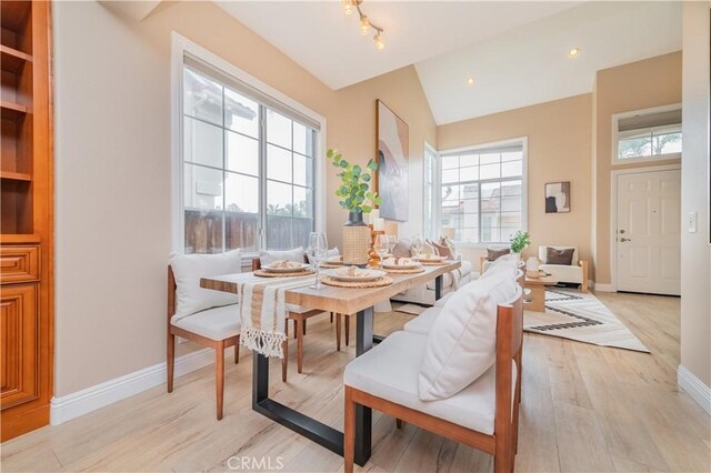 56 Egret Ln, Aliso Viejo, CA 92656 - dining space with light wood-style floors, baseboards, and lofted ceiling