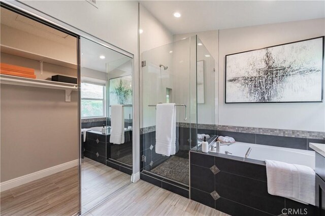 56 Egret Ln, Aliso Viejo, CA 92656 - bathroom with a garden tub, a shower stall, wood finished floors, baseboards, and recessed lighting