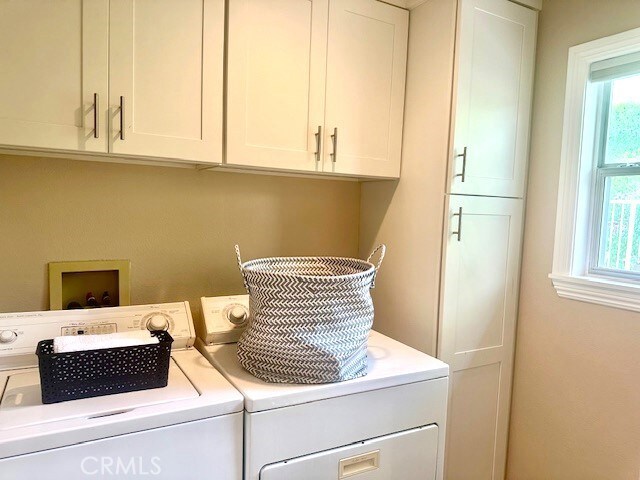 56 Egret Ln, Aliso Viejo, CA 92656 - laundry area with washing machine and clothes dryer and cabinet space