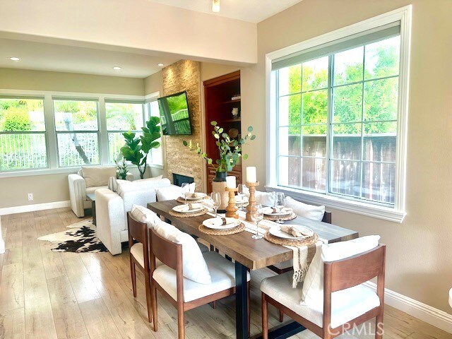 56 Egret Ln, Aliso Viejo, CA 92656 - dining area with healthy amount of natural light, baseboards, and light wood-style flooring