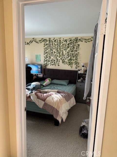 carpeted bedroom with crown molding