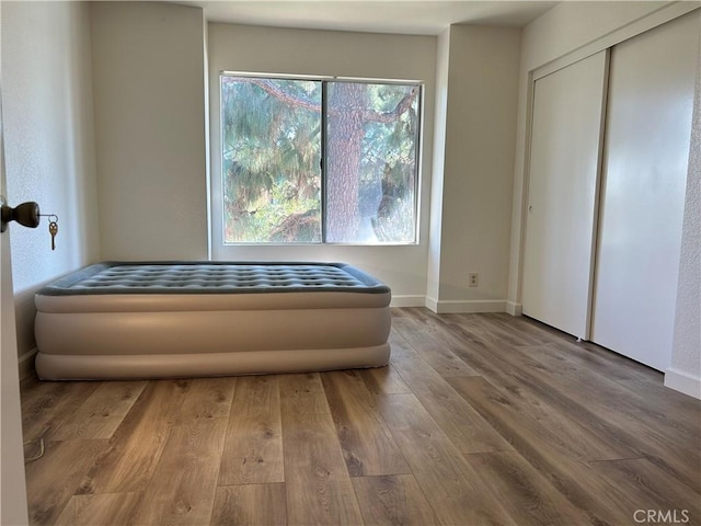 12121 Centralia St Unit 305, Lakewood, CA 90715 - interior space featuring a closet, baseboards, wood finished floors, and multiple windows