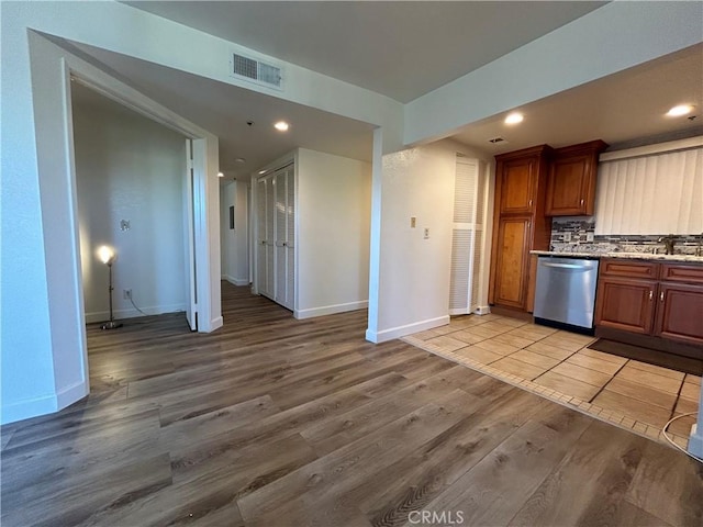 12121 Centralia St Unit 305, Lakewood, CA 90715 - kitchen with a sink, baseboards, light wood-style flooring, and dishwasher