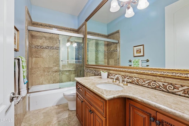 full bathroom featuring tile patterned flooring, vanity, toilet, shower / bath combination with glass door, and a notable chandelier