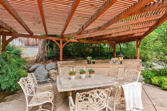 view of patio with a pergola and outdoor dining space