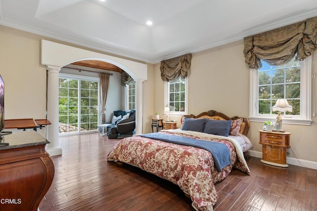 bedroom with dark wood-style floors, multiple windows, and access to exterior