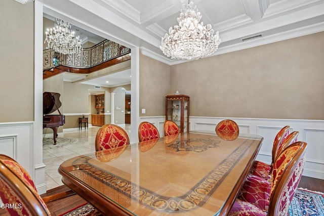 dining space featuring visible vents, crown molding, wainscoting, beam ceiling, and a notable chandelier