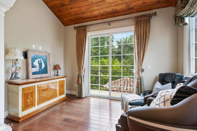 living area with wood ceiling, baseboards, vaulted ceiling, and wood finished floors