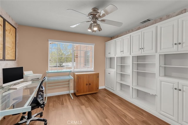 office area with visible vents, a ceiling fan, light wood-style floors, and baseboards