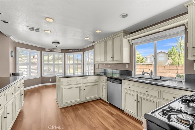 kitchen with stainless steel dishwasher, a peninsula, visible vents, and light wood-style floors