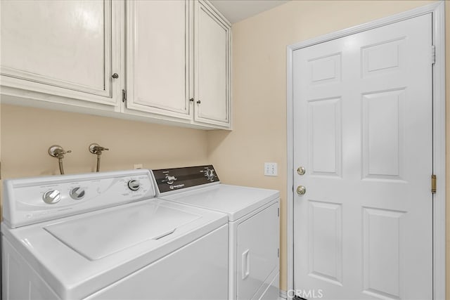 washroom featuring cabinet space and washer and dryer