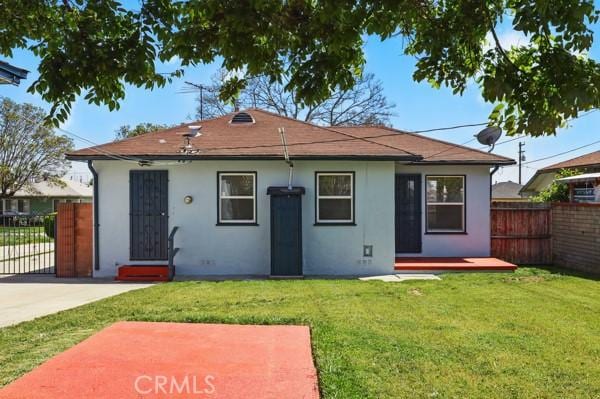 325 W Floral Dr, Monterey Park, CA 91754 - back of house featuring fence, stucco siding, a yard, and a deck