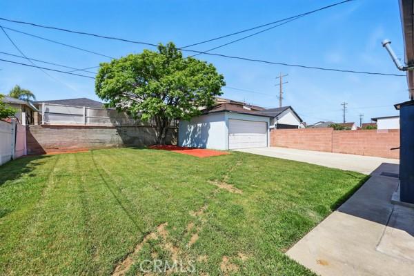 325 W Floral Dr, Monterey Park, CA 91754 - view of yard with a garage, a fenced backyard, and concrete driveway