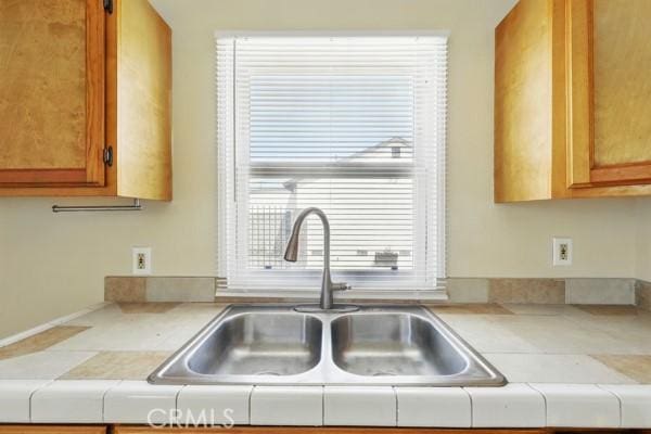 325 W Floral Dr, Monterey Park, CA 91754 - kitchen featuring a sink, brown cabinets, and light countertops